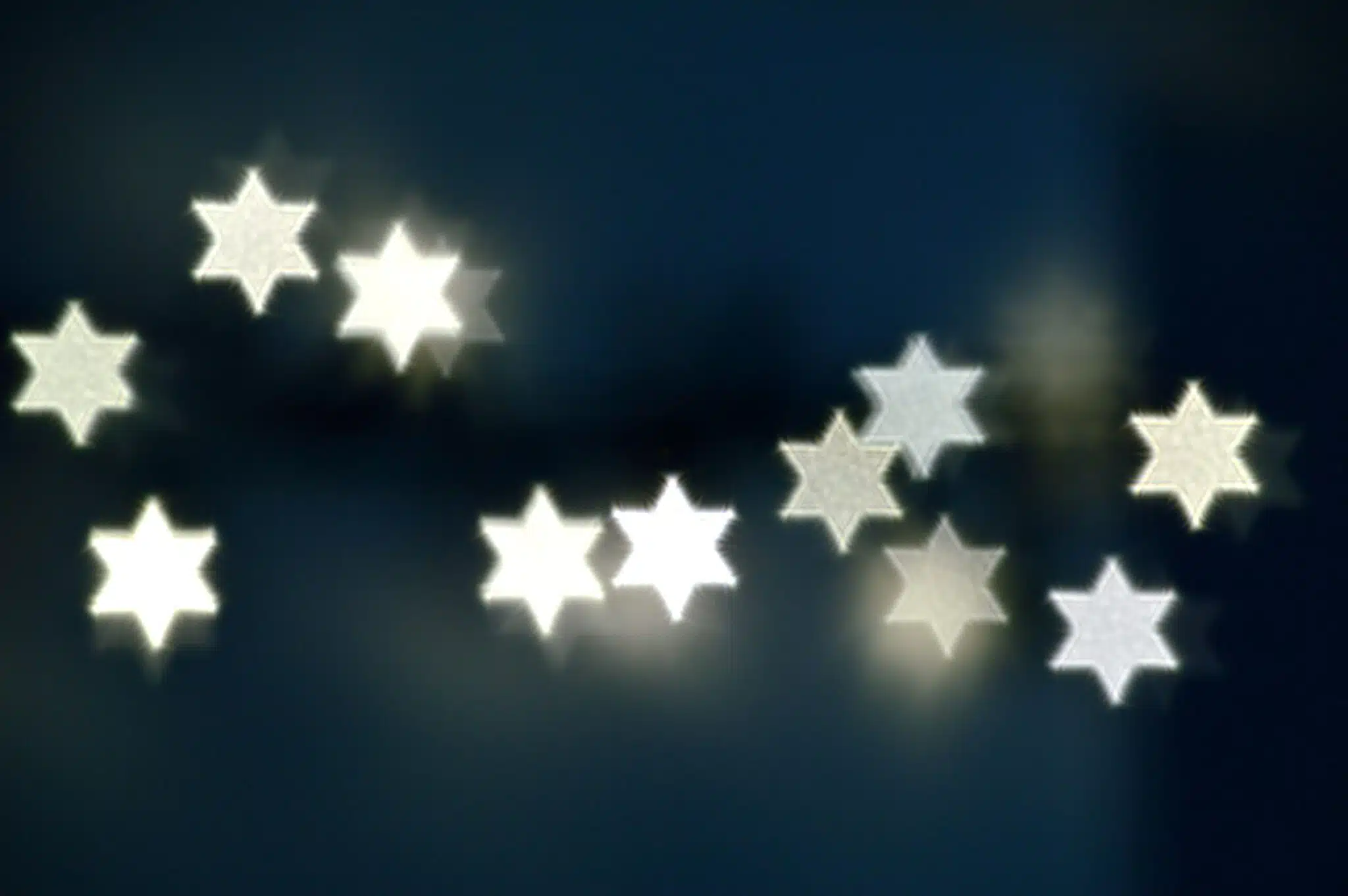 String lights shaped like stars glowing in the dark.